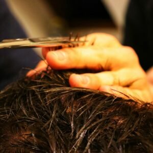 a person cutting a hair